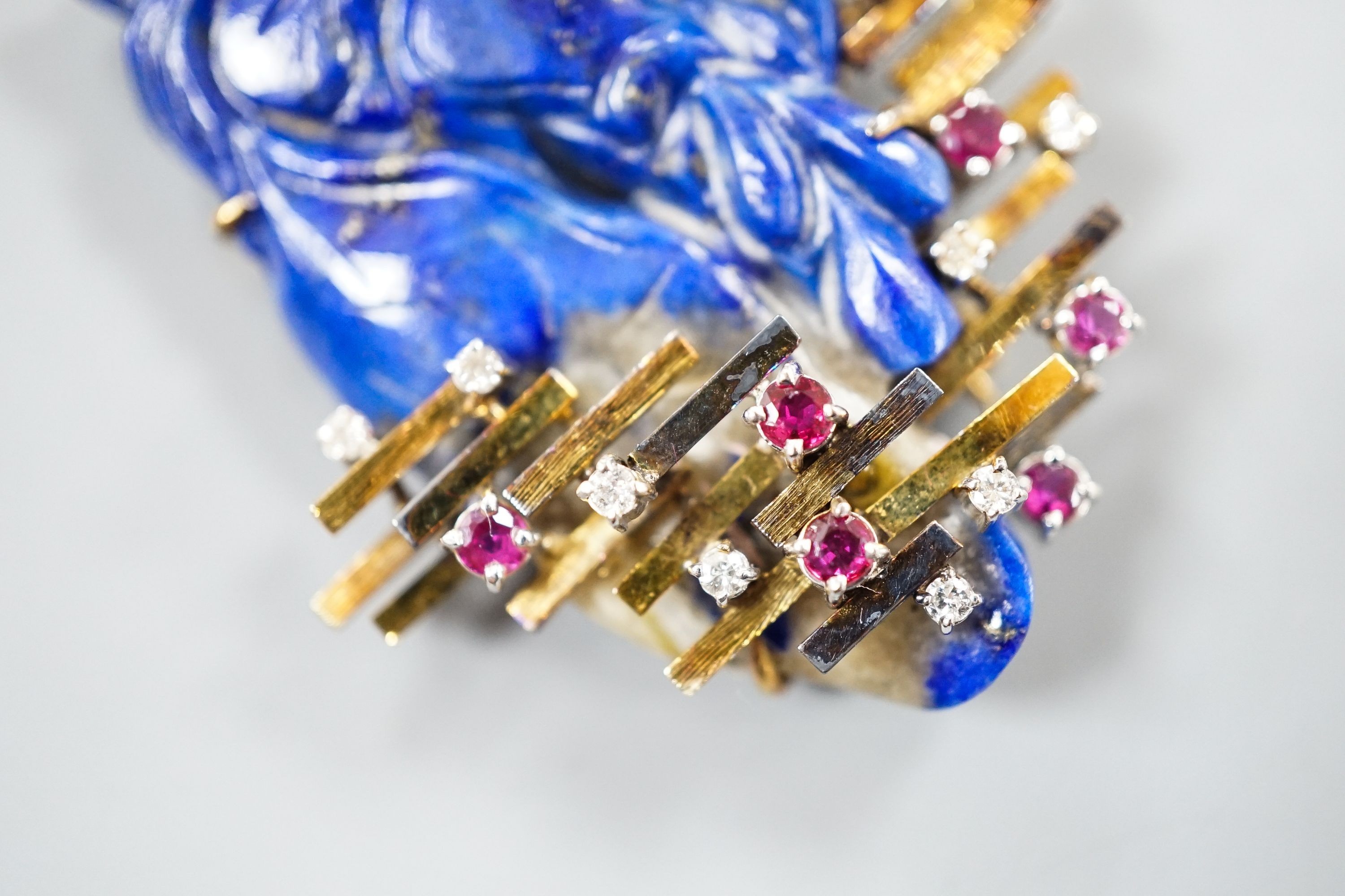 A 585 yellow metal, ruby, diamond and apis lazuli set modernist brooch, maker's mark KK, width 52mm, gross weight 21.4 grams